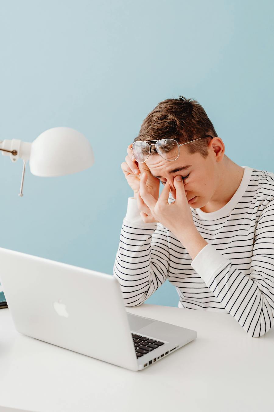 teenage boy showing signs of anxiety while working on homework | The Peaceful Mind Counseling Center