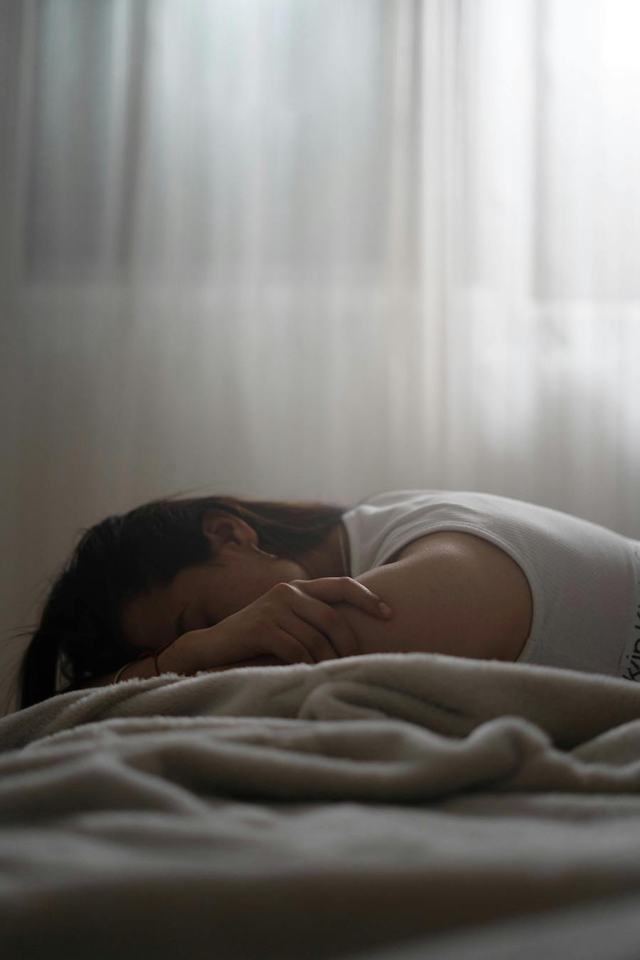 depressed teenager in bed | The Peaceful Mind Counseling Center